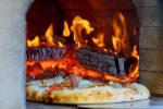 Verdichtete Holzscheite kochen auf einem Holzfeuer – Bild 3
